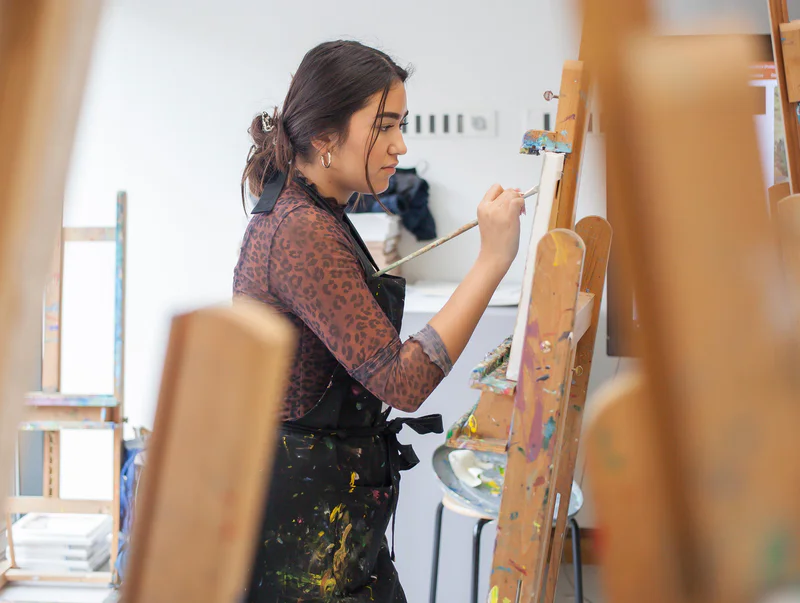 Een vrouw is aan het schilderen in het workshopatelier van het Van Gogh Museum. Foto: Les Adu